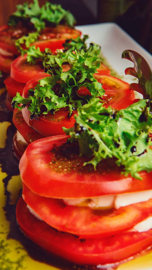 Tomatoe salad with olive oil, balsamic vinegar and lettuce